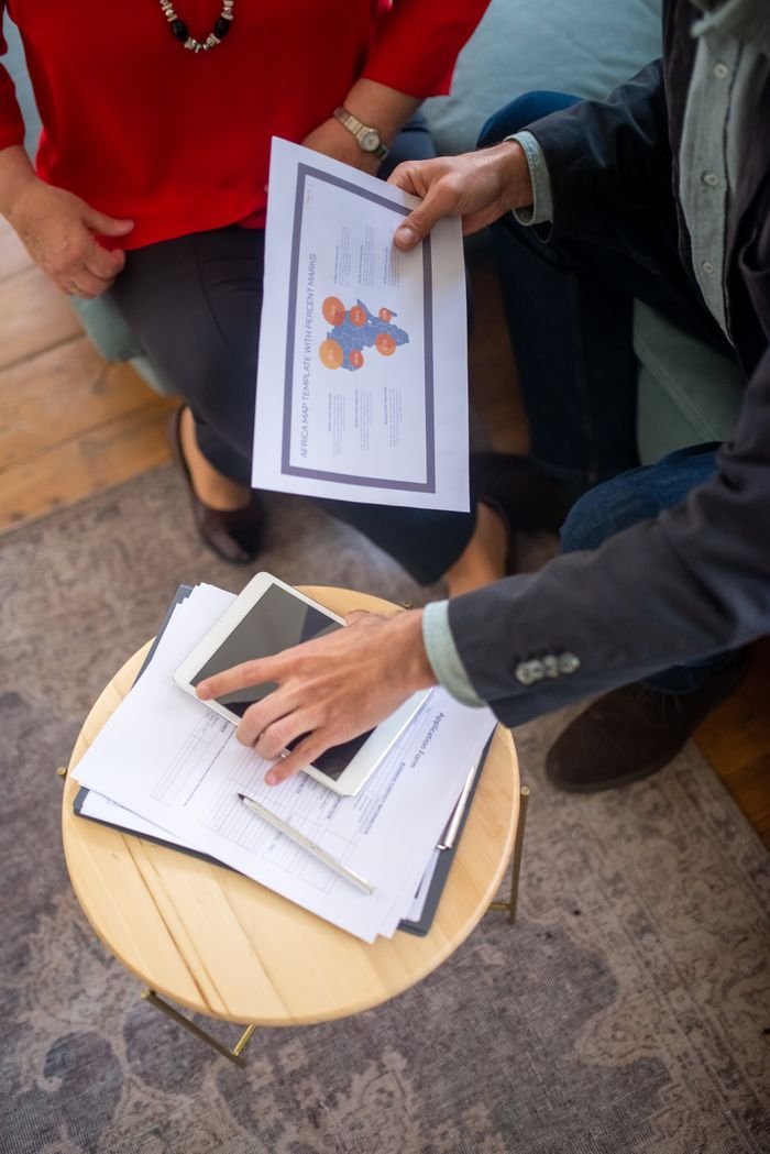 Hello world! Overhead view of a business meeting with documents and a tablet, showcasing collaboration.